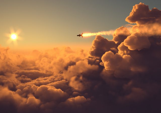 Missile fly above the clouds at sunset