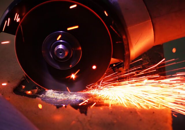 Cutting metal with disc grinder with bright sparks
