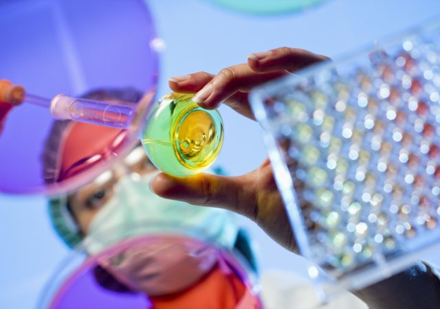 Technician at a laboratory surrounded by lab tools